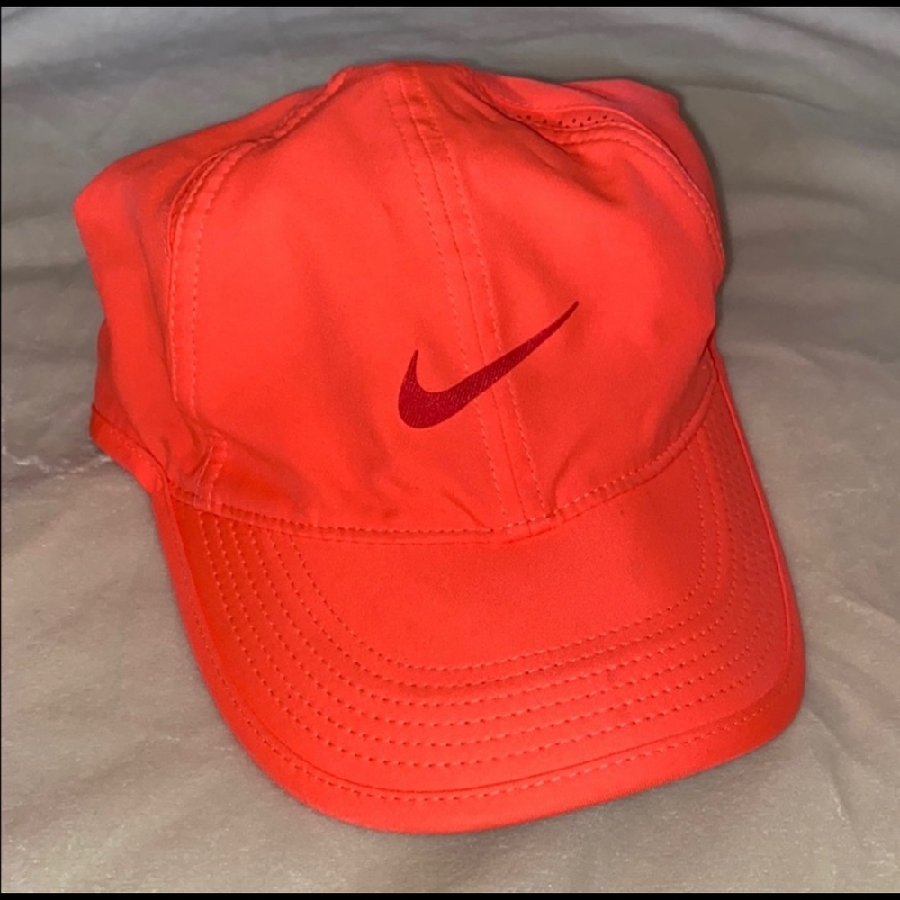 Two coral Nike hats